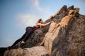 Female extreme climber conquers steep rock