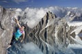 Female extreme climber hanging on cliff over the