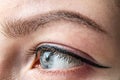 Female eye of blue color of a young girl close-up. Eye and eyebrow makeup.Permanent makeup for eyelids and eyebrows Royalty Free Stock Photo