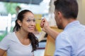 female on eye glasses test