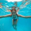 Female with eyes open underwater in swimming pool