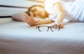 Woman eyesight problem hand searching her eyeglasses on bedroom