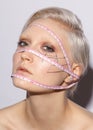 Female face with measure ribbon, conceptual photo beauty standarts