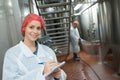 Female factory supervisor wearing hairnet and taking notes Royalty Free Stock Photo