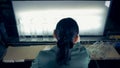 Female factory worker is throwing away defective vitreous bottles from the conveyor belt