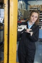 Female Factory Worker Using Powered Fork Lift To Load Goods Royalty Free Stock Photo