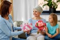 Female family giving present to grandmother Royalty Free Stock Photo