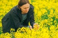 Female farmer in blooming rapeseed field Royalty Free Stock Photo