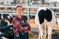 Female farmer in cow shed on a dairy livestock farm Royalty Free Stock Photo