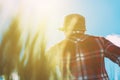 Female farmer looking at the sun on the horizon