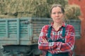 Female farmer posing in front of hay wagon Royalty Free Stock Photo