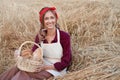 Female farmer sitting wheat agricultural field Woman baker holding wicker basket bread product Royalty Free Stock Photo