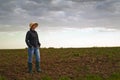 Female Farmer Standing on Fertile Agricultural Farm Land Soil Royalty Free Stock Photo