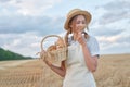 Female farmer standing wheat agricultural field Woman baker holding wicker basket bread product Royalty Free Stock Photo