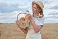 Female farmer standing wheat agricultural field Woman baker holding wicker basket bread product Royalty Free Stock Photo