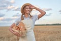 Female farmer standing wheat agricultural field Woman baker holding wicker basket bread product Royalty Free Stock Photo