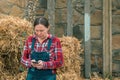 Female farmer typing sms message on mobile phone Royalty Free Stock Photo