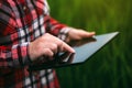 Female farmer using tablet computer in barley crop field Royalty Free Stock Photo