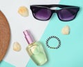 Female fashion accessories on a blue white pastel background. Sunglasses, perfume bottle, cockleshells, hat. Summer beach Royalty Free Stock Photo