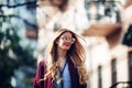 Female fashion concept. Outdoor waist up portrait of young beautiful woman posing on old street. Model wearing stylish clothes, lo Royalty Free Stock Photo