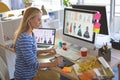 Female fashion designer using graphic tablet while working at desk Royalty Free Stock Photo