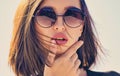 Female fashion model posing with sunglasses. Close-up portrait of a beautiful charming young attractive lady. Portrait Royalty Free Stock Photo