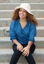 Female fashion model sitting on stairs outdoors and laughing Royalty Free Stock Photo