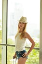 Attractive woman wearing sun hat and white top