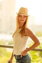 Attractive woman wearing sun hat and white top