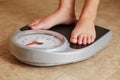 Female feet on a bathroom scale Royalty Free Stock Photo