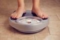 Female feet on a bathroom scale Royalty Free Stock Photo