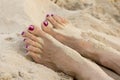 Female feet on the beach covered in sand Royalty Free Stock Photo