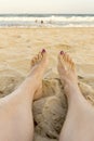 Female feet on the beach woman watching ocean Royalty Free Stock Photo