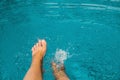 Female feet in blue water pool Royalty Free Stock Photo