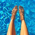 Female feet in blue water Royalty Free Stock Photo