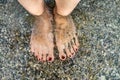 Female feet in clear sea water