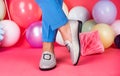 female feet in comfortable shoes loafers at colorful balloons, fashion