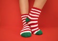 Female feet in fluffy New Year or Christmas warm socks. The colors of the socks Royalty Free Stock Photo