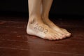 female feet on the old wooden floor of the house with the inscription 2022 on the leg, happy new year