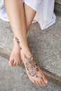 Female feet painted with henna