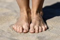 Female feet on the sand, beach by the sea. Royalty Free Stock Photo