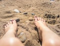 Female feet on the sand under the bright sun Royalty Free Stock Photo