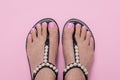 Female feet in sandals, pink pedicure. Woman summer shoes. Nail care concept, chiropody Royalty Free Stock Photo