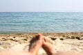 Female feet, sandy beach and sea in the background. Picture with soft focus and place for your text. summer concept. Enjoying the Royalty Free Stock Photo