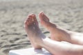 Female feet on the sandy beach