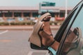 Female feet in shoes sticking out of a car window Royalty Free Stock Photo