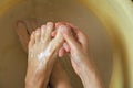 Female feet in soapy water, washing in a plastic bowl
