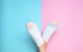 Female feet in socks on a pastel background. Copy space. Top view.
