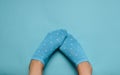 Female feet in socks on a pastel background. Copy space. Top view.