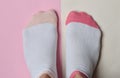 Female feet in socks on a pastel background. Copy space. Top view.